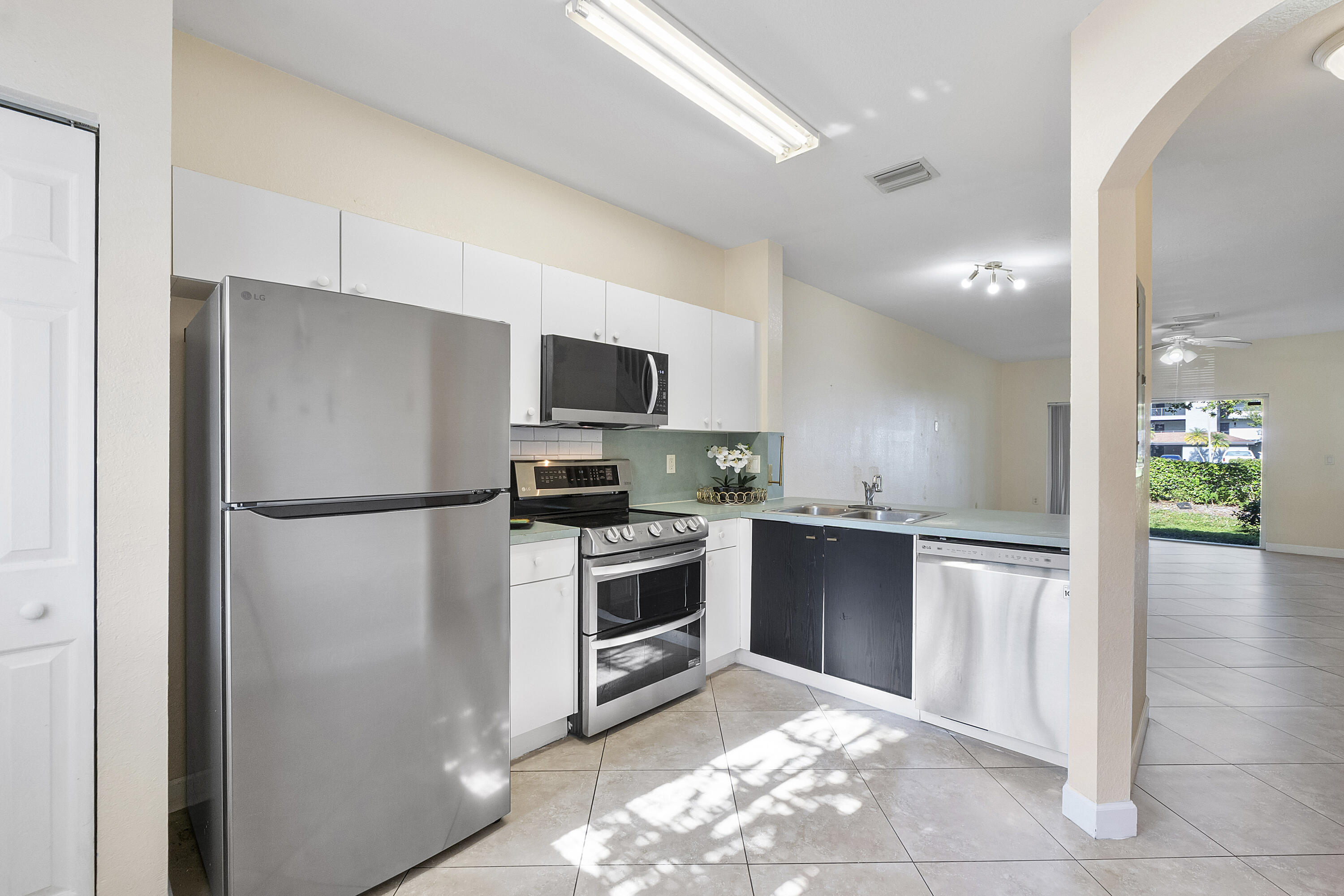 5910 Riverside Avenue Tamarac, FL 33321 - Photo 9 of 47 a kitchen with a refrigerator stove and microwave