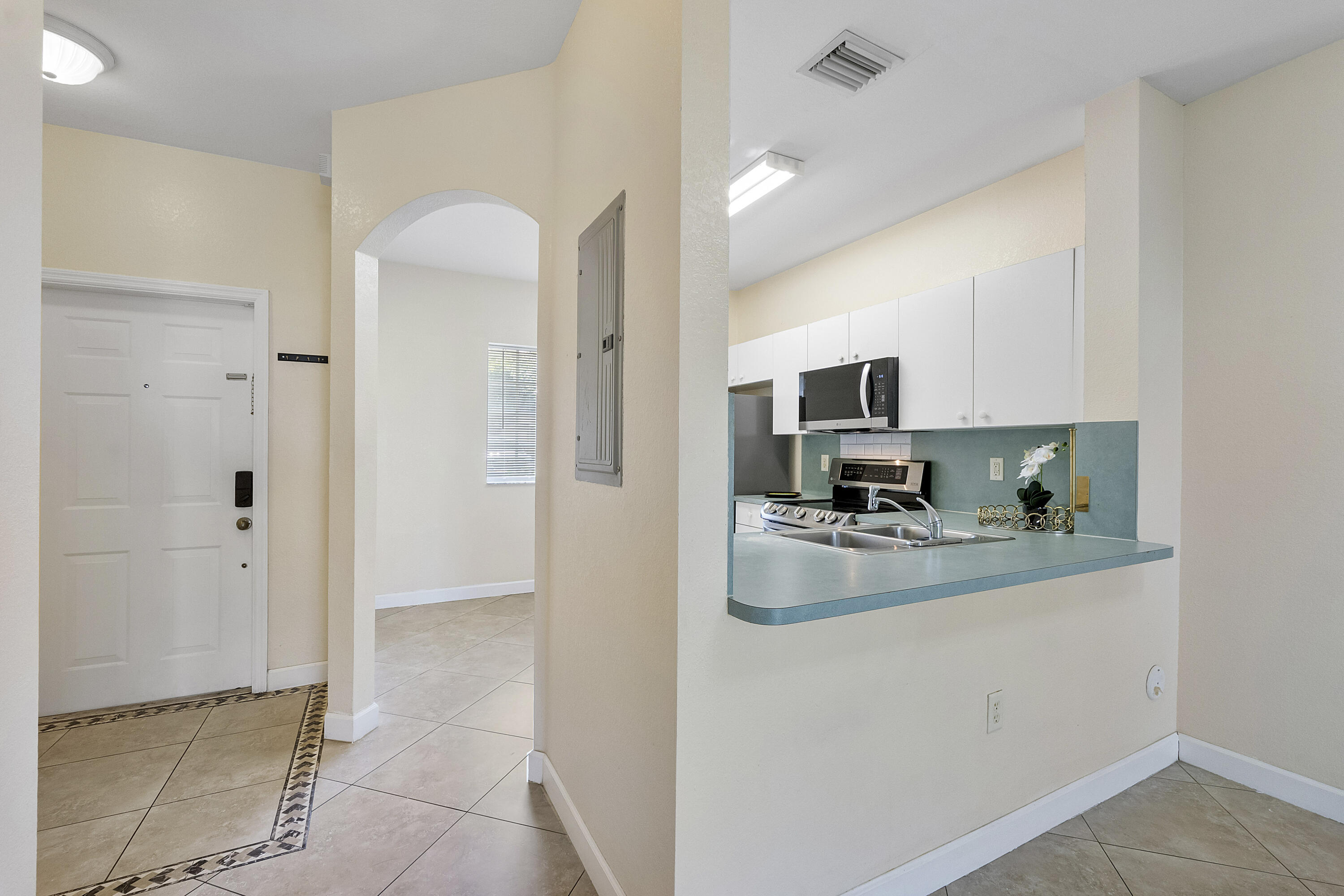 5910 Riverside Avenue Tamarac, FL 33321 - Photo 10 of 47 a kitchen with a refrigerator and a sink
