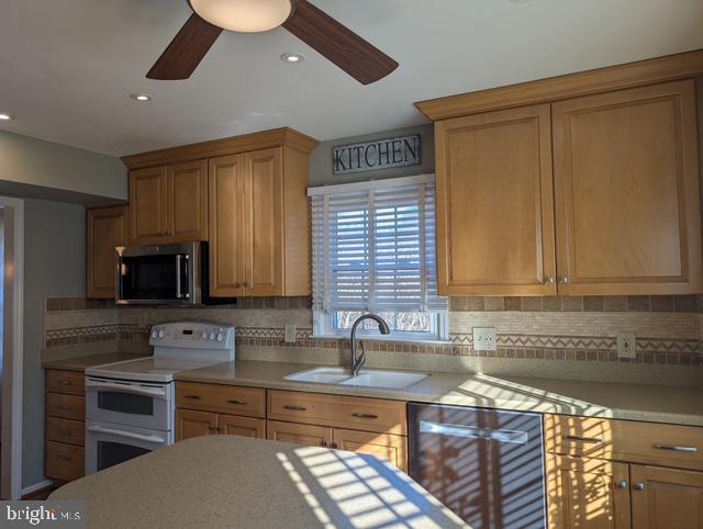18 Kings Bridge Court Newark, DE 19702 - Photo 15 of 38 a kitchen with stainless steel appliances granite countertop a sink and a stove