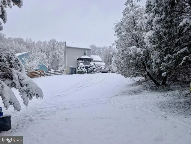 a view of a house with a snow in the yard