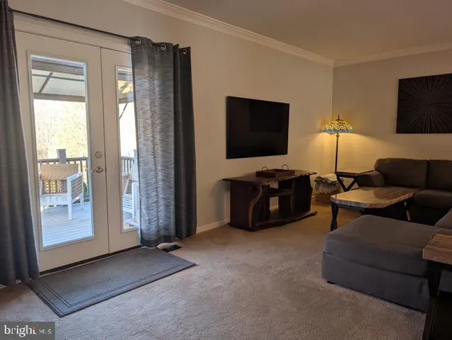 a dining room with furniture a rug and a chandelier