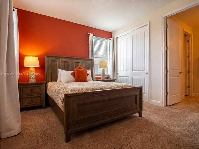 a bed sitting in a bedroom next to a window