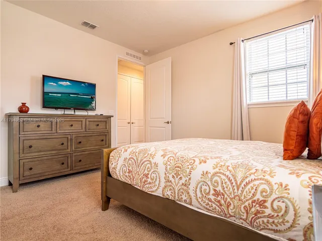 a bedroom with a bed and flat screen tv