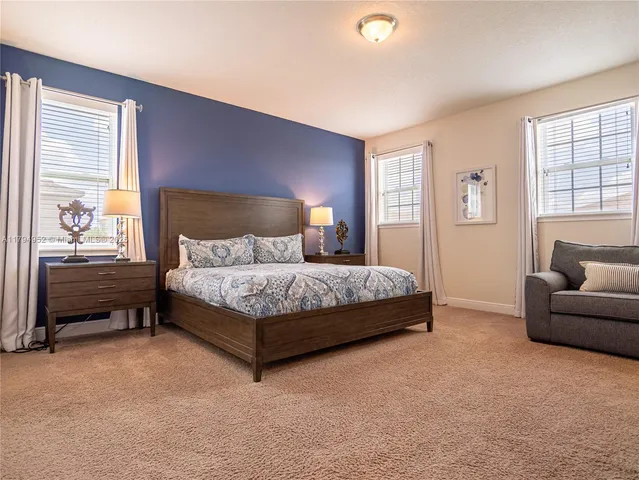 a bedroom with a bed and a couch