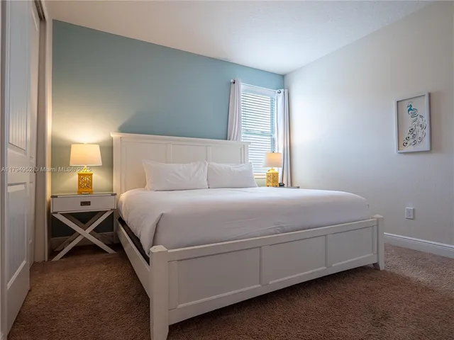 a bedroom with a bed and a table in it