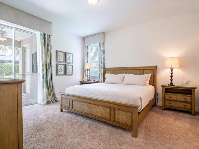 a spacious bedroom with a bed and a window