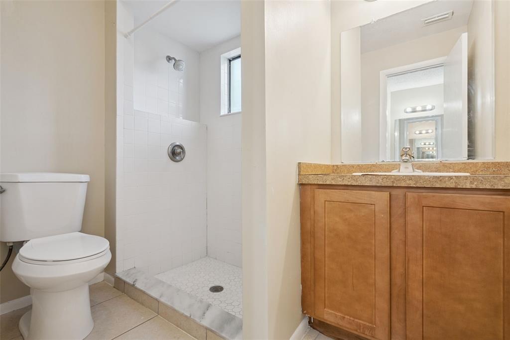 505 Tiberon Cove Road Longwood, FL 32750 - Photo 17 of 20 a bathroom with a granite countertop sink a toilet and a mirror