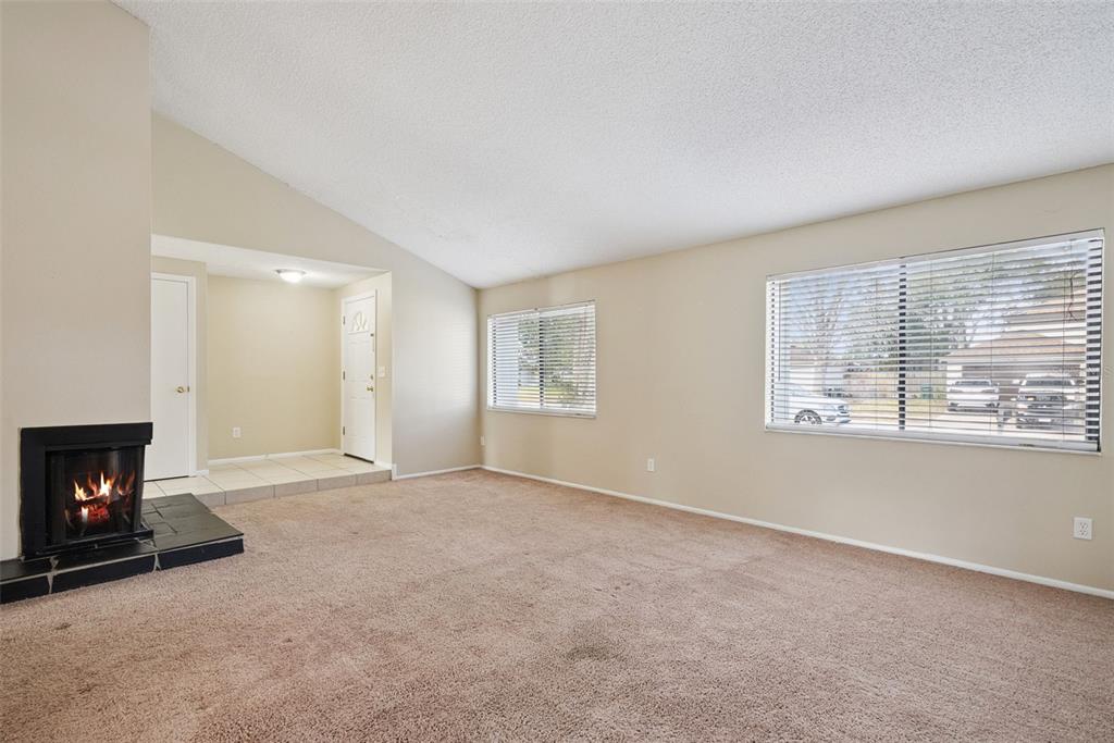 505 Tiberon Cove Road Longwood, FL 32750 - Photo 4 of 20 a view of an empty room with a window and fireplace