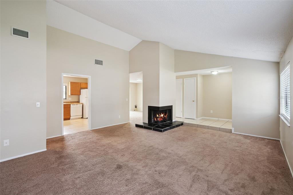 505 Tiberon Cove Road Longwood, FL 32750 - Photo 6 of 20 a view of an empty room with a fireplace