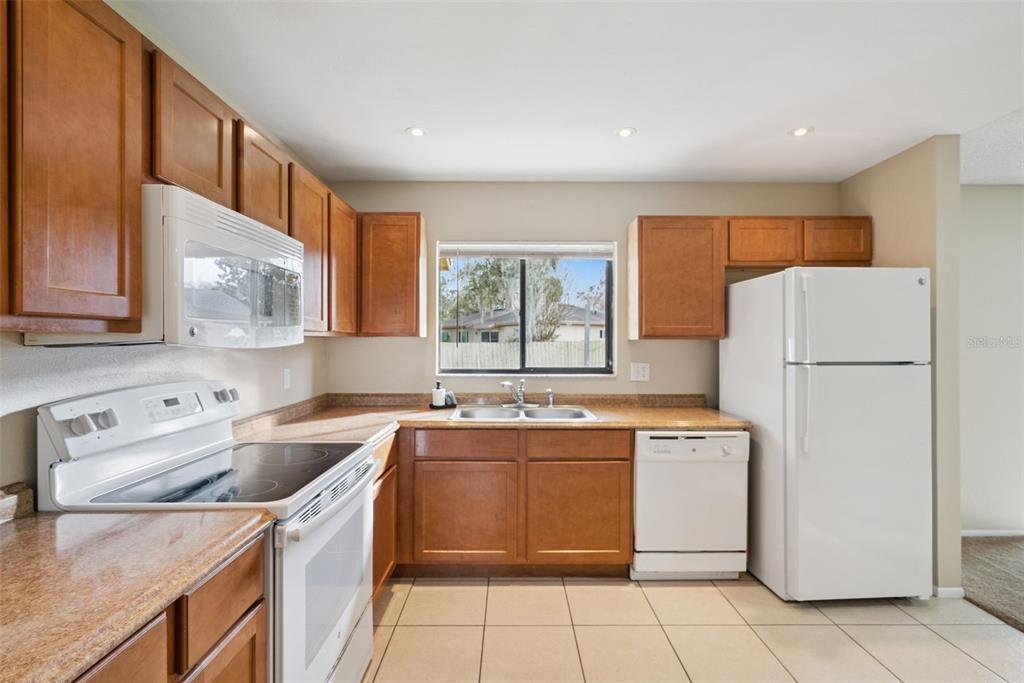 505 Tiberon Cove Road Longwood, FL 32750 - Photo 10 of 20 a kitchen with a stove a refrigerator and a sink