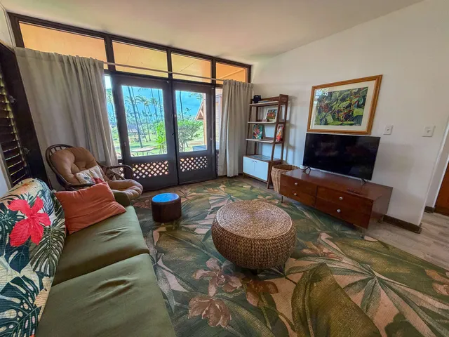 a living room with furniture and a floor to ceiling window