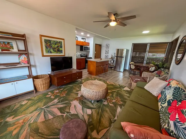 a living room with furniture and a flat screen tv