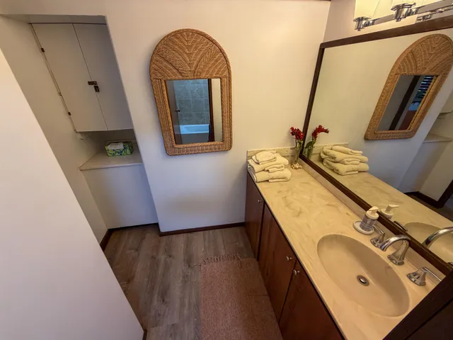 a bathroom with a granite countertop sink and a mirror
