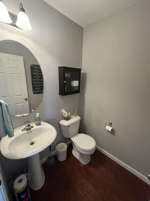 2212 Rising Hill Road Whitehall, PA 18052 - Photo 6 of 21 A well-maintained bathroom with warm wood flooring and a modern pedestal sink, perfect for daily routines.