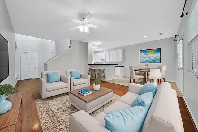 a living room with furniture and kitchen view