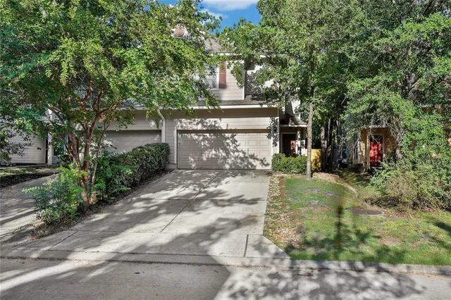 a view of a street with trees and bushes