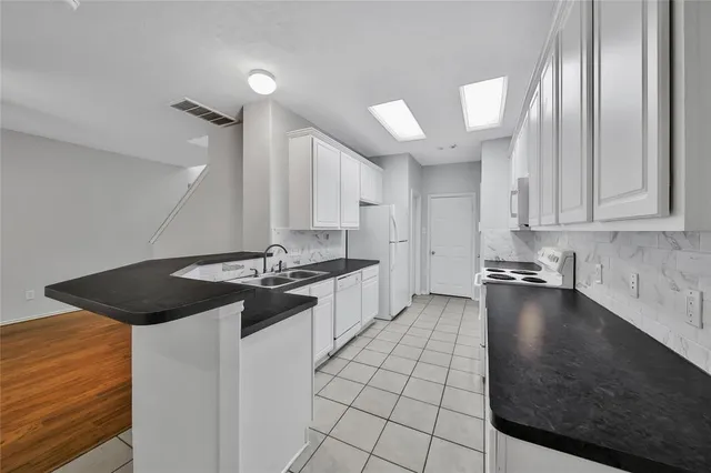 a kitchen with a sink cabinets and appliances