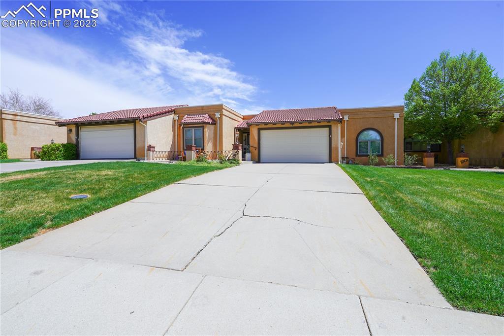 a front view of a house with a yard and garage