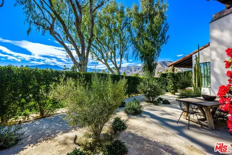 a view of a backyard with sitting area