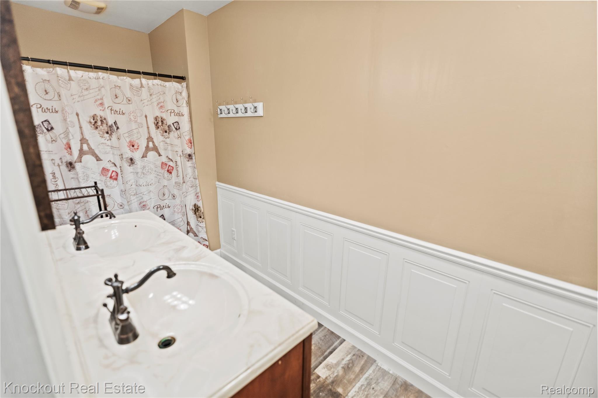 5750 Maple Road Frankenmuth, MI 48734 - Photo 29 of 60 Dual vanity with integrated sinks, oil-rubbed bronze faucets, and a wood-finish cabinet