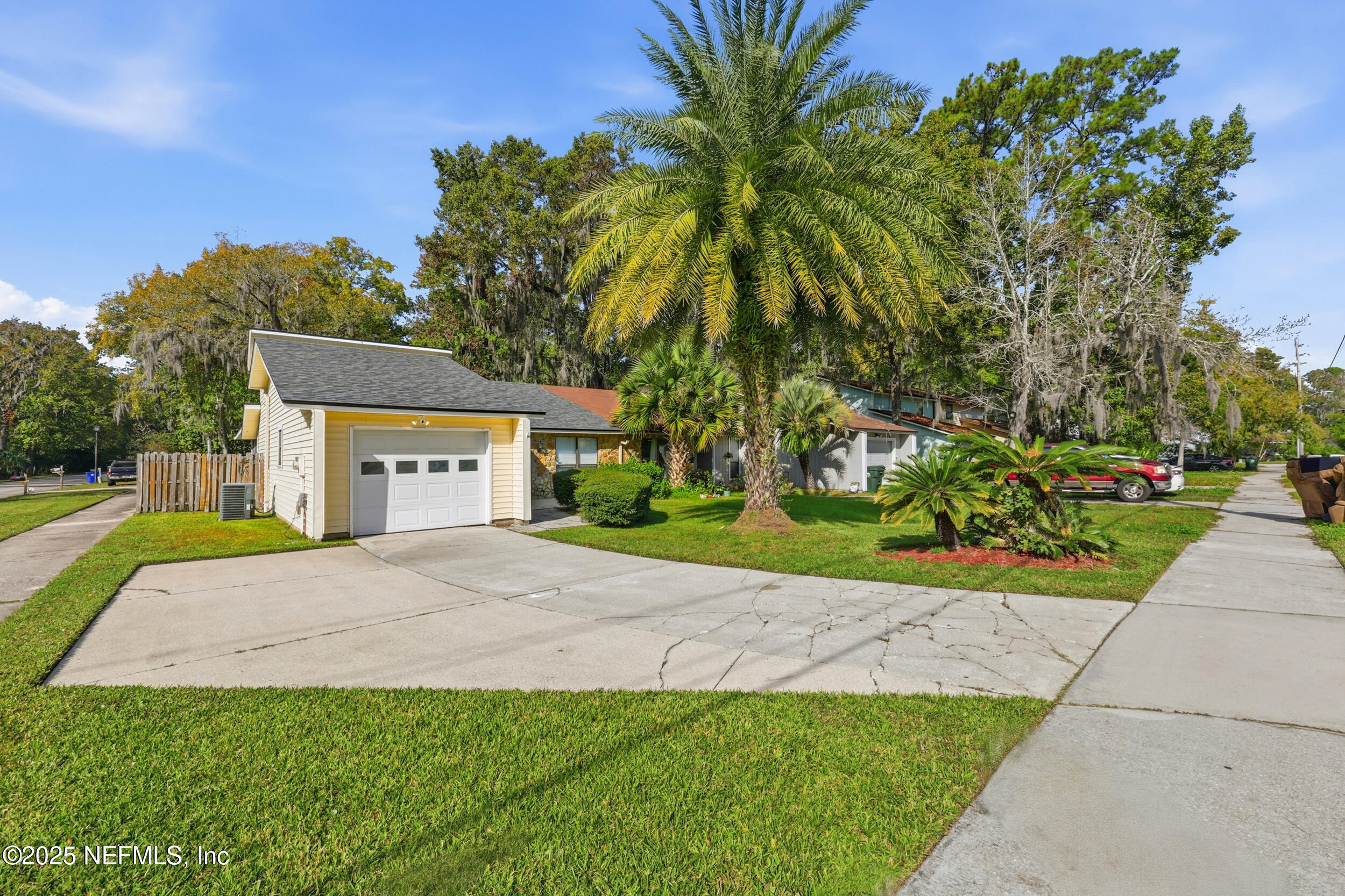 760 Plainfield Avenue Orange Park, FL 32073 - Photo 13 of 38 a front view of a house with a yard and a garage