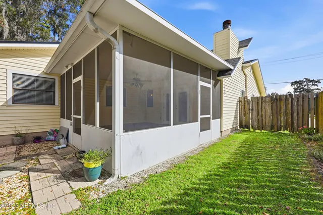 a view of a house with a backyard