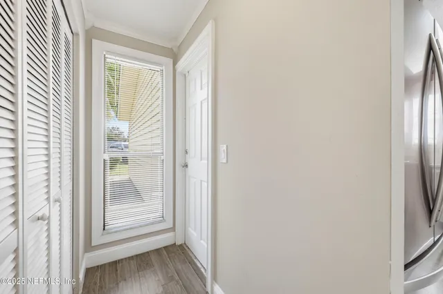 an empty room with wooden floor and ceiling fan