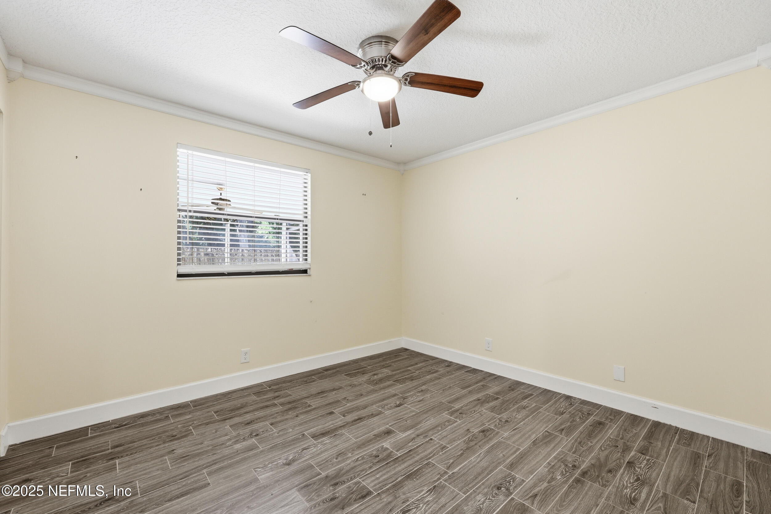 760 Plainfield Avenue Orange Park, FL 32073 - Photo 21 of 38 an empty room with wooden floor and ceiling fan