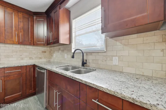 a kitchen with stainless steel appliances granite countertop a stove microwave and refrigerator