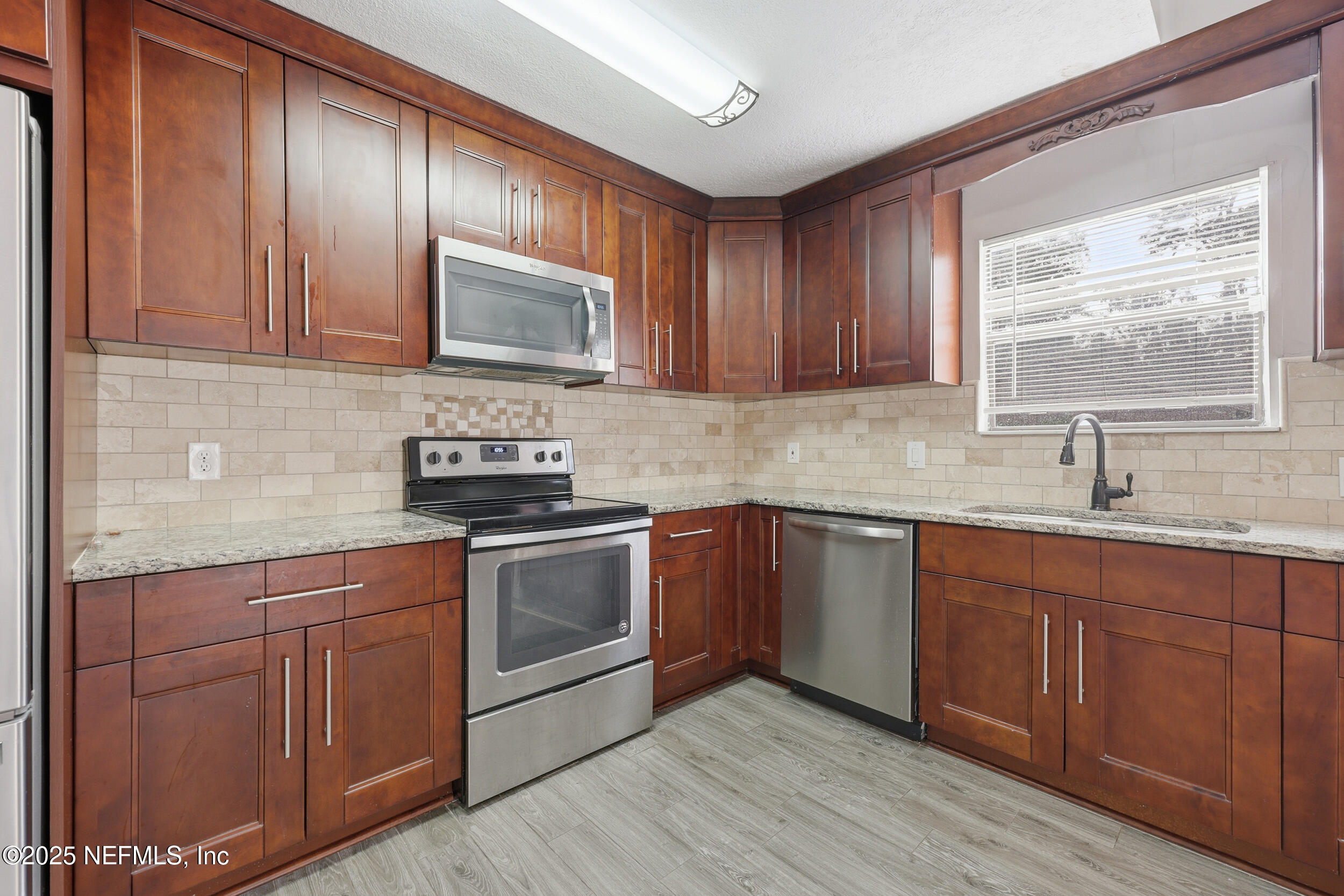 760 Plainfield Avenue Orange Park, FL 32073 - Photo 29 of 38 a kitchen with cabinets a sink and appliances