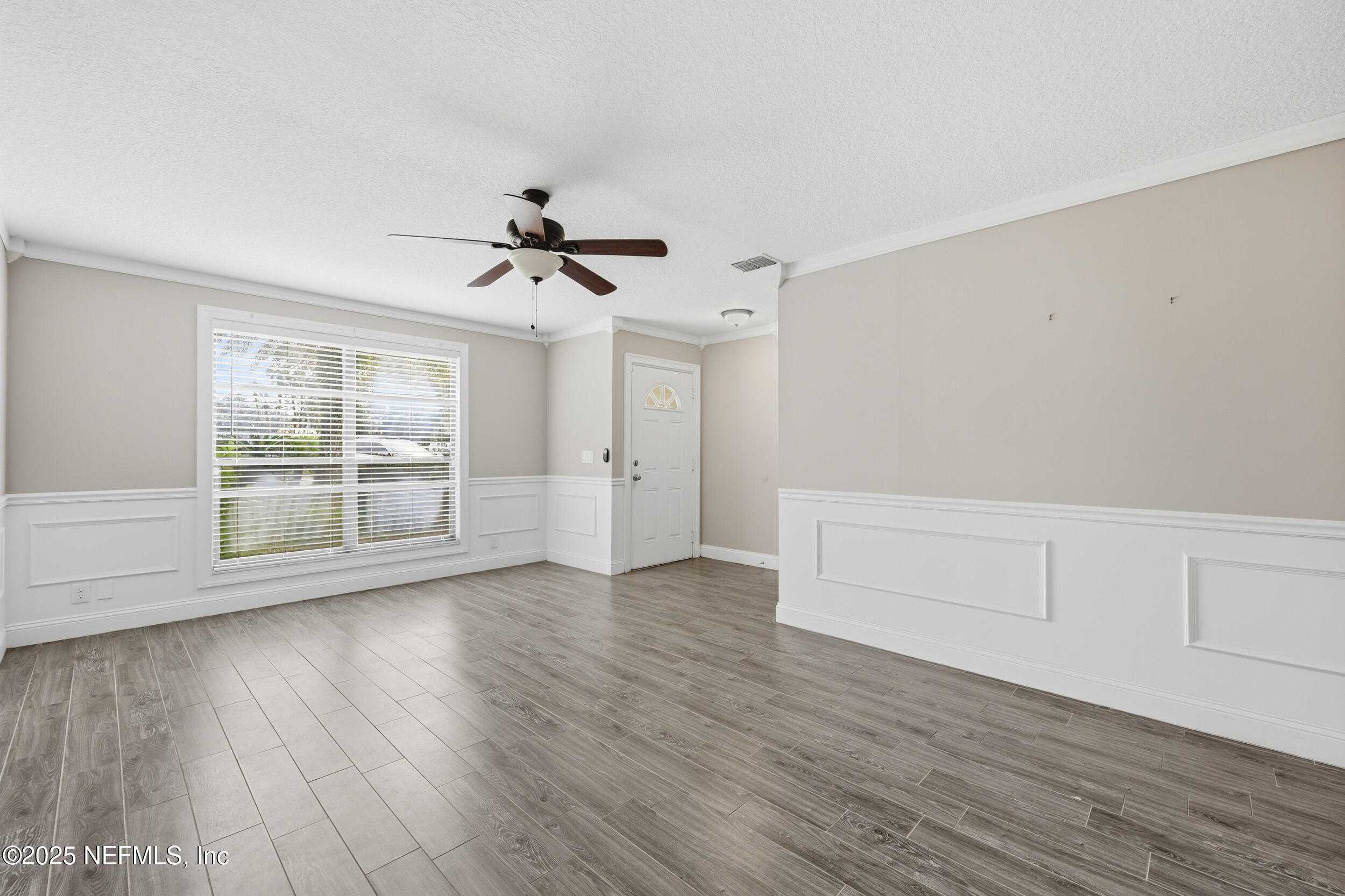 760 Plainfield Avenue Orange Park, FL 32073 - Photo 33 of 38 a view of an empty room with wooden floor and a window