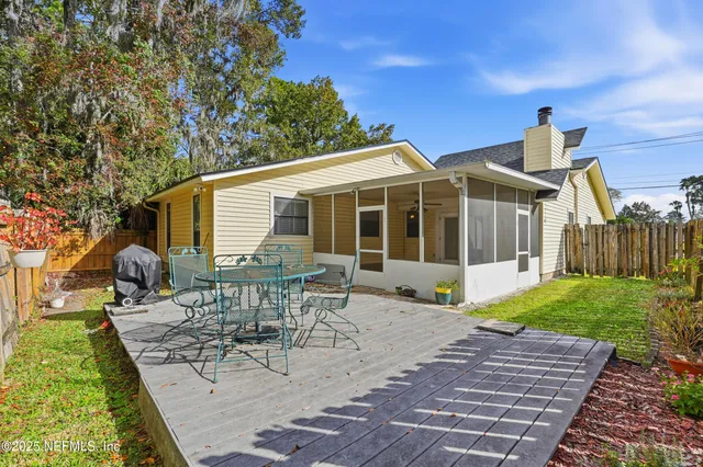 a view of a house with backyard sitting area and garden
