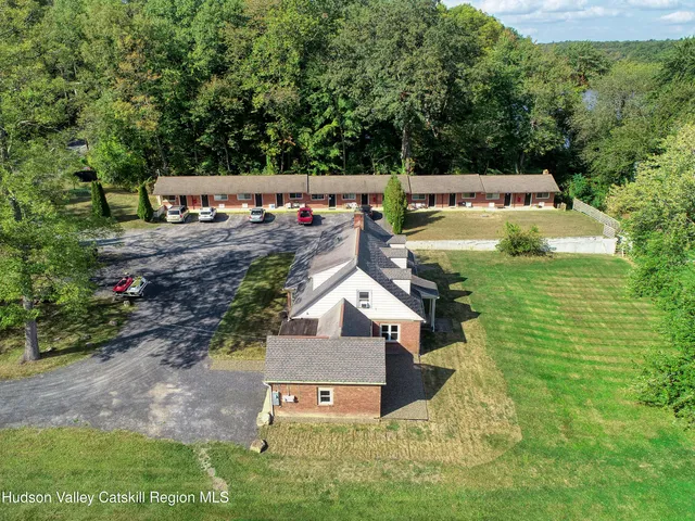 an aerial view of a house with swimming pool garden and patio