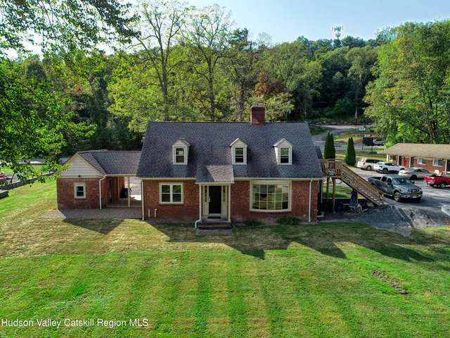 an aerial view of a house with a big yard