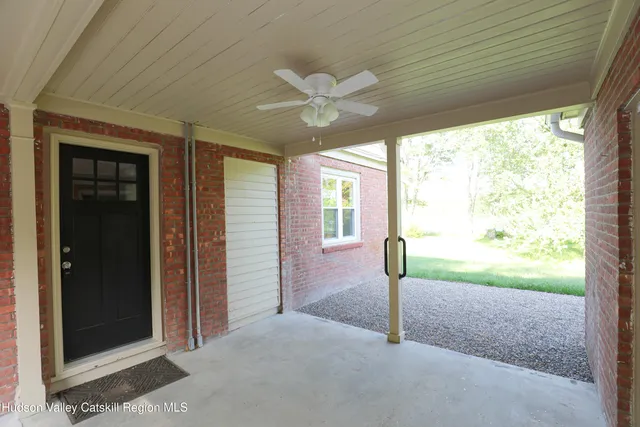 a view of a porch with a table and chairs