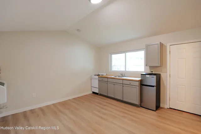 a kitchen with a refrigerator and window