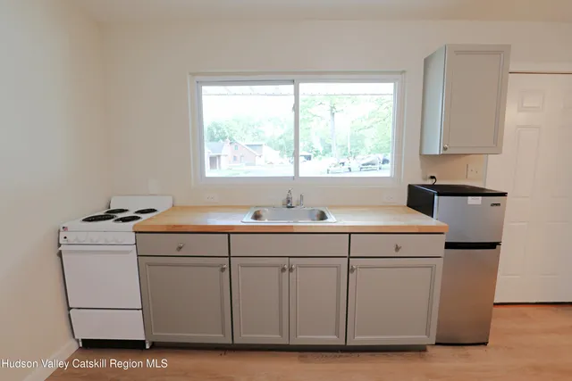 a utility room with sink dryer and washer