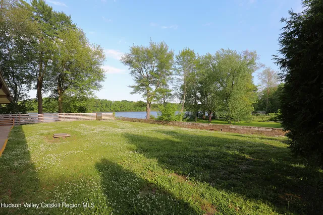a view of yard with swimming pool and trees