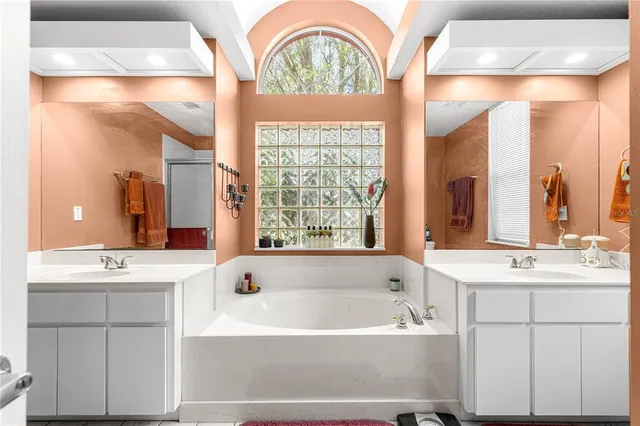 a bath room with a sink and a window