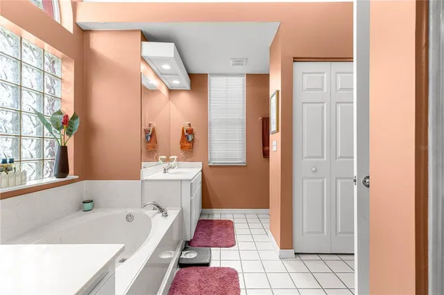 a bathroom with a bathtub sink and mirror