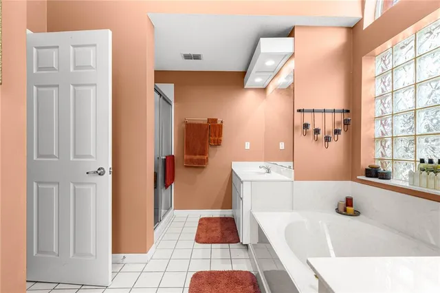 a view of a hallway with wooden floor and dining room view