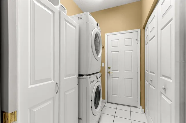 a living room with furniture a rug and a floor to ceiling window