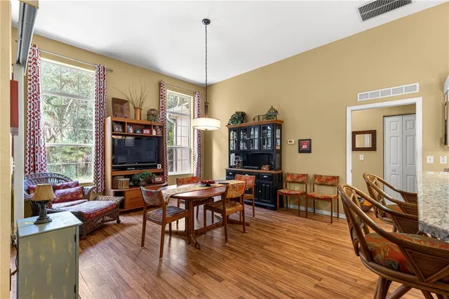 a living room with furniture a flat screen tv and a floor to ceiling window
