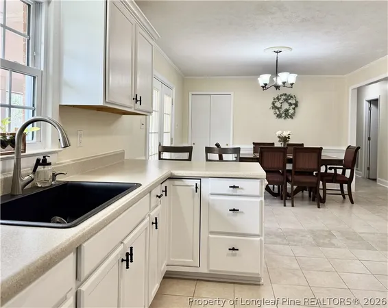 a kitchen with a table chairs and refrigerator