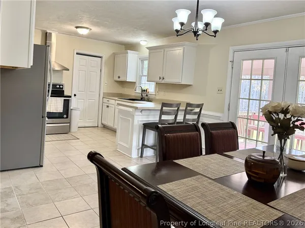 a kitchen with stainless steel appliances granite countertop a refrigerator stove top oven and sink
