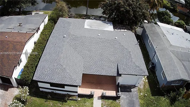 an aerial view of a house with a yard