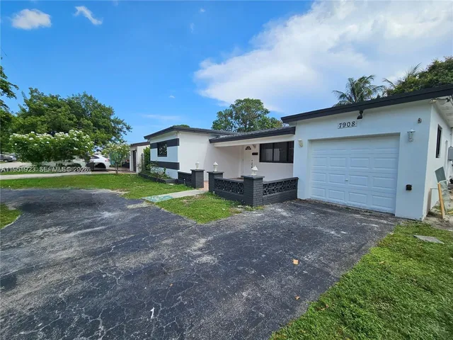 a view of a house with a yard and garage