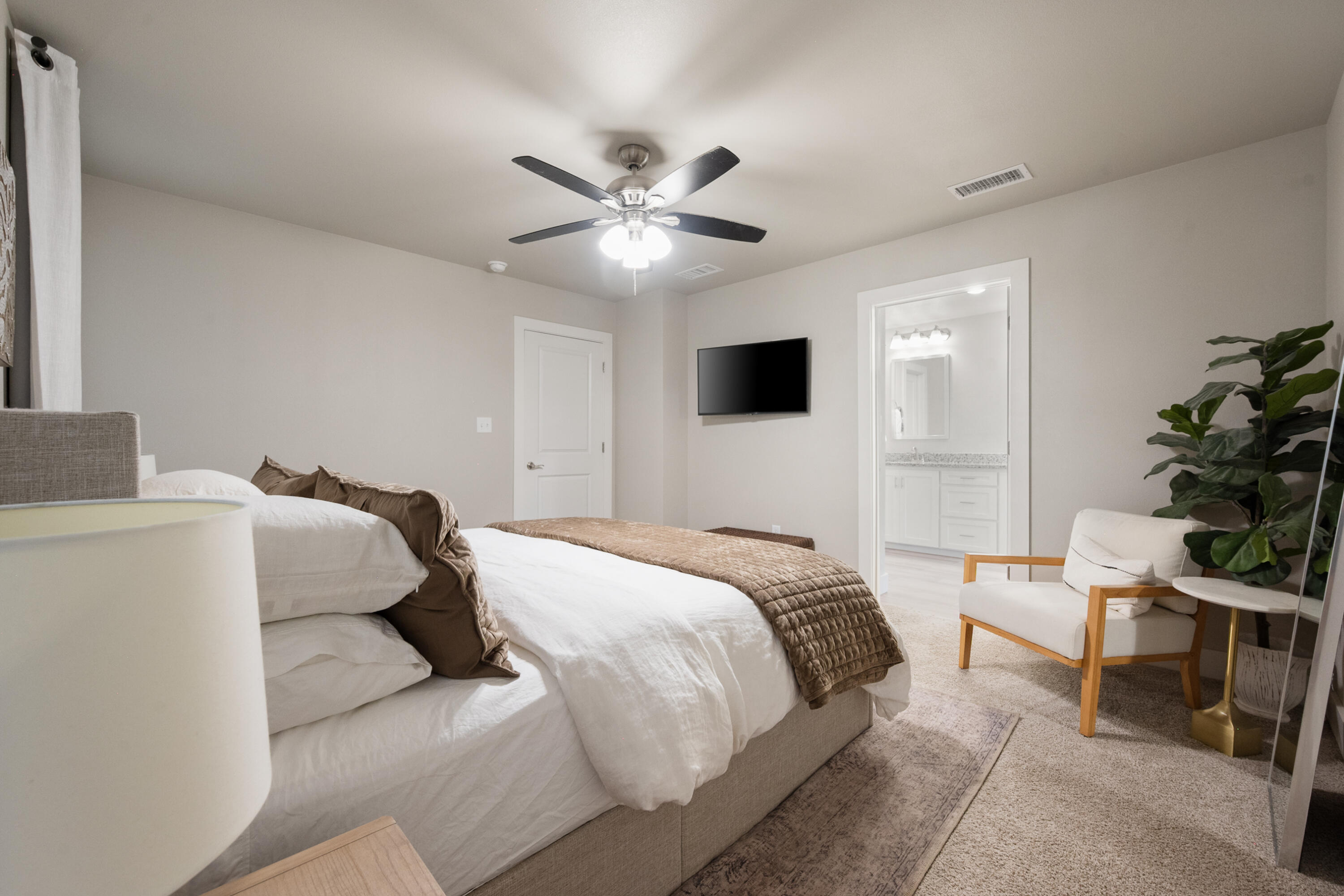 2908 137th Street Lubbock, TX 79423 - Photo 18 of 31 a bedroom with a bed and a chandelier