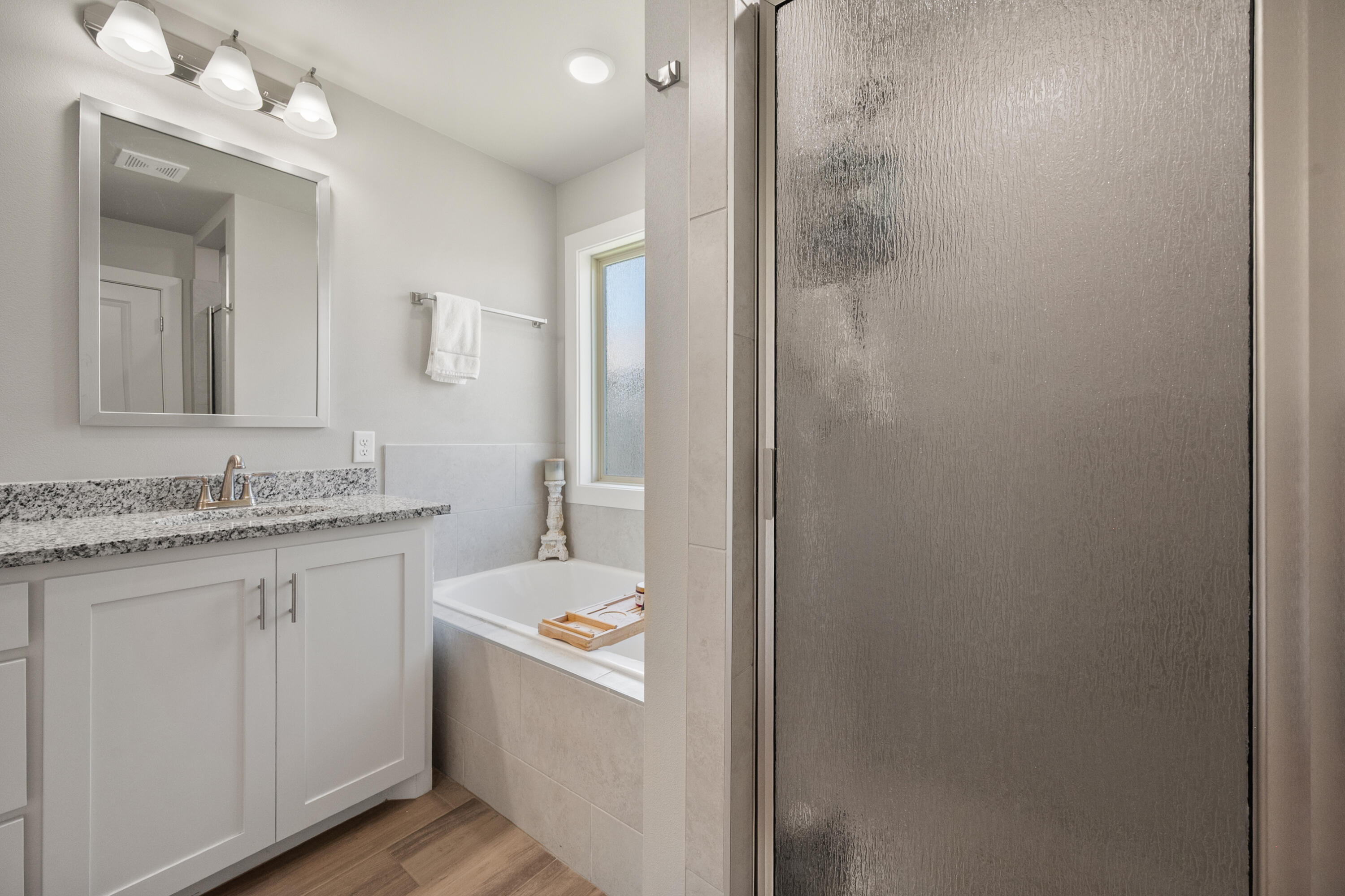 2908 137th Street Lubbock, TX 79423 - Photo 23 of 31 a bathroom with a granite countertop sink a toilet and a mirror