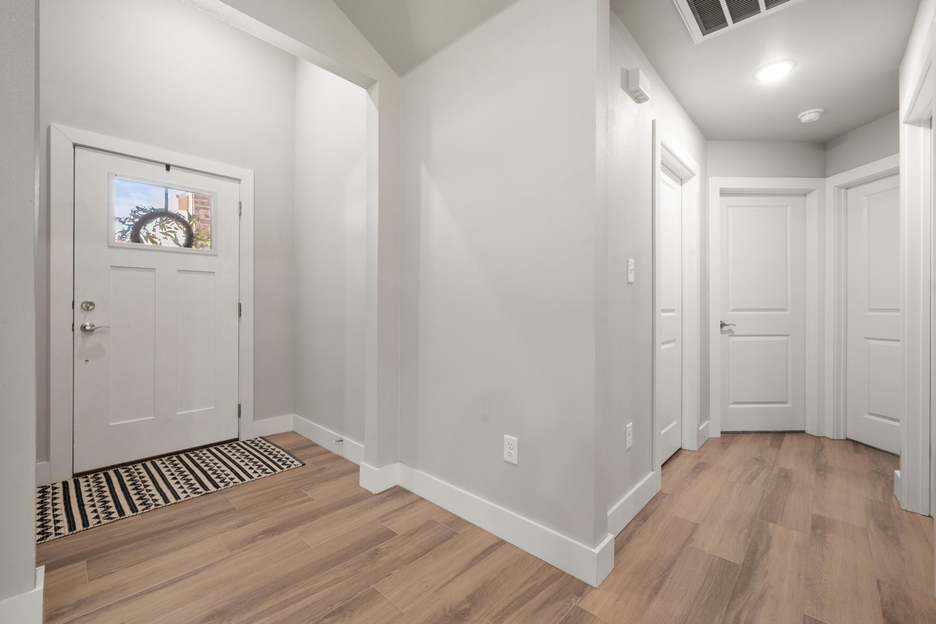 2908 137th Street Lubbock, TX 79423 - Photo 4 of 31 an empty room with wooden floor and windows